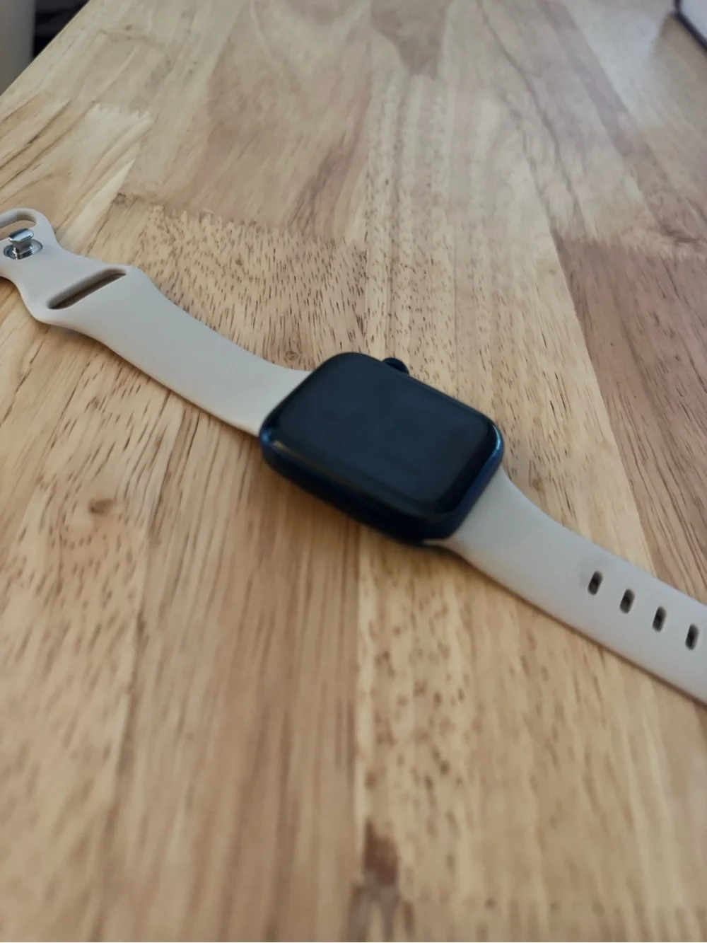 Apple Smartwatch with Light Beige Silicone Band and Black Face